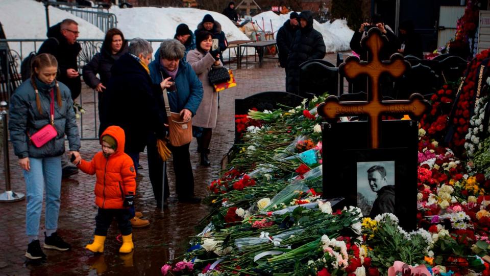 PHOTO: People lay flowers at the grave of Russian opposition leader Alexei Navalny to honor his memory at the Borisov Cemetery in Moscow. (Artem Priakhin / Sopa Images/Sipa USA via AP)