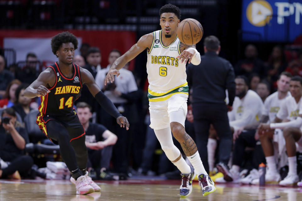 Houston Rockets forward K.J. Martin (6) passes the ball away from Atlanta Hawks forward AJ Griffin (14) during the first half of an NBA basketball game Friday, Nov. 25, 2022, in Houston. (AP Photo/Michael Wyke)