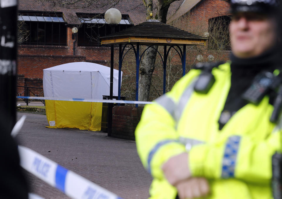 Police officer secures the area as a police tent covers the the spot in Salisbury where former Russian spy double agent Sergei Skripal and his daughter were found critically ill (AP Photo/Frank Augstein)