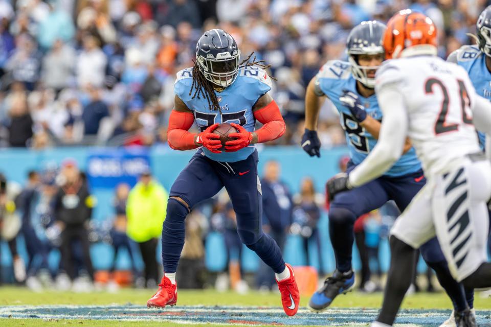 Tennessee Titans running back Derrick Henry (22) runs the ball against the Cincinnati Bengals in an NFL football game, Sunday, Nov. 27, 2022, in Nashville, Tenn. Bengals won 20-16.