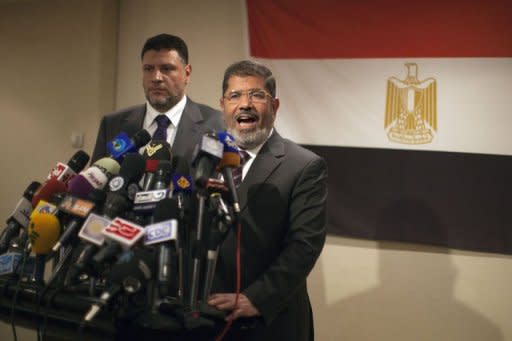 Muslim Brotherhood Egyptian presidential candidate Mohammed Mursi (R) gives a press conference in Cairo. The Muslim Brotherhood today urged Egyptians to rally behind their presidential candidate in an almost certain run-off with rival Ahmed Shafiq, warning the country would be in danger if fallen dictator Hosni Mubarak's premier wins