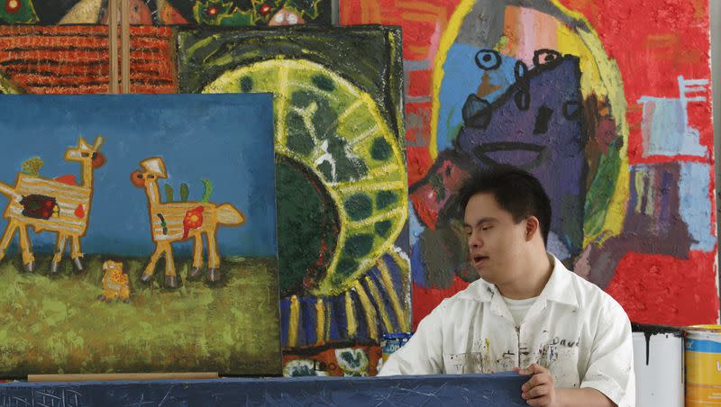 An artist moves paintings in a studio at the Mexican School of Down Art in Mexico City on Friday, Oct. 19, 2007. World Down Syndrome Day takes place every year on March 21.