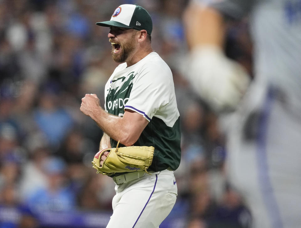 Colorado Rockies starting pitcher Austin Gomber, back, reacts after getting Kansas City Royals' Kyle Isbel to fly out to end the top of the seventh inning of a baseball game Saturday, July 6, 2024, in Denver. (AP Photo/David Zalubowski)