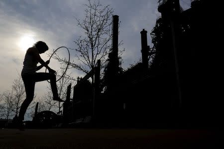 Erin Stealey practises with her hoop next to the blast furnaces of the now-closed Bethlehem Steel mill in Bethlehem, Pennsylvania, U.S. April 21, 2016. REUTERS/Brian Snyder