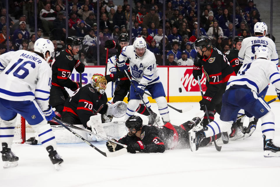 Ottawa Senators goaltender Joonas Korpisalo (70) watches the puck as teammates fight for control against the Toronto Maple Leafs during the final minute of play in the third period of NHL hockey game action in Ottawa, Ontario, Saturday, Feb. 10, 2024. (Sean Kilpatrick/The Canadian Press via AP)