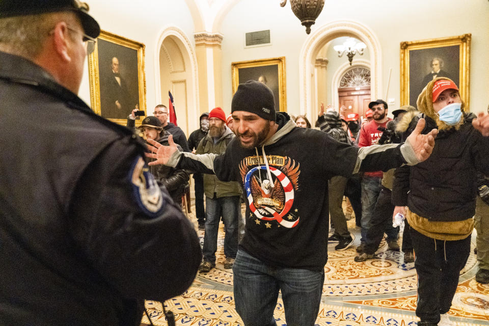 Supporters of President Donald Trump are confronted by Capitol Police officers outside the Senate Chamber at the Capitol, Wednesday, Jan. 6, 2021 in Washington. (AP Photo/Manuel Balce Ceneta)