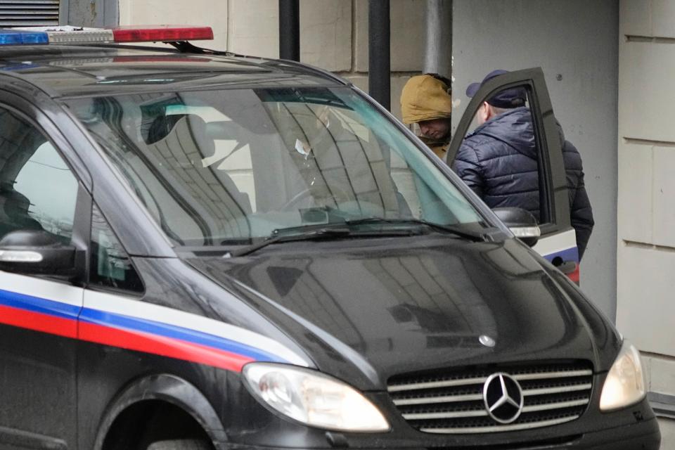 Reporter for the Wall Street Journal Evan Gershkovich is escorted by officers from the Lefortovsky court to a bus, in Moscow, Russia, (Copyright 2023 The Associated Press. All rights reserved.)