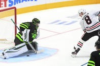 Chicago Blackhawks left wing Dominik Kubalik (8) scores on Dallas Stars goaltender Anton Khudobin (35) during the first period of an NHL hockey game in Dallas, Thursday, March 11, 2021. (AP Photo/Matt Strasen)