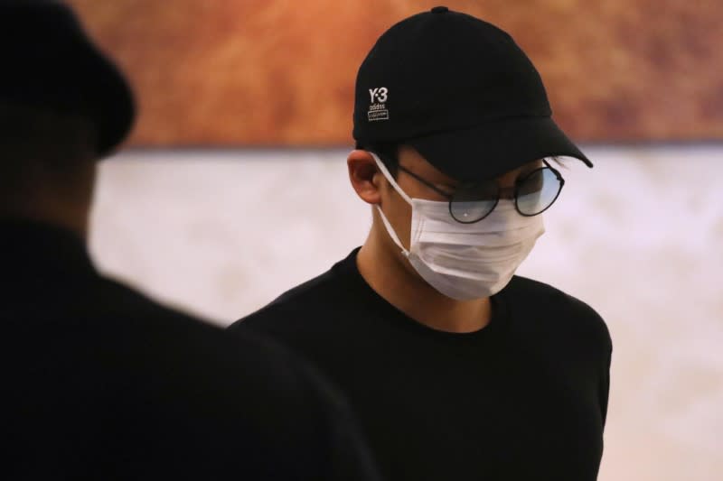 Japanese badminton player Kento Momota arrives at Kuala Lumpur International Airport, as he leaves for Tokyo, after he was released from hospital following an injury in a vehicle collision on Monday, in Sepang