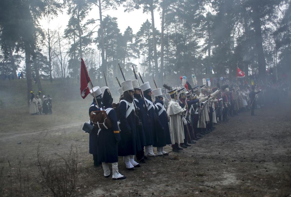 Men dressed as 1812-era Russian and French soldiers re-enact a staged battle in the town of Borisov, 70 km (44 miles) east of Minsk, Belarus, Saturday, Nov. 23, 2019, to mark the 207th anniversary of the Berezina battle during Napoleon's army retreat from Russia. (AP Photo/Sergei Grits)