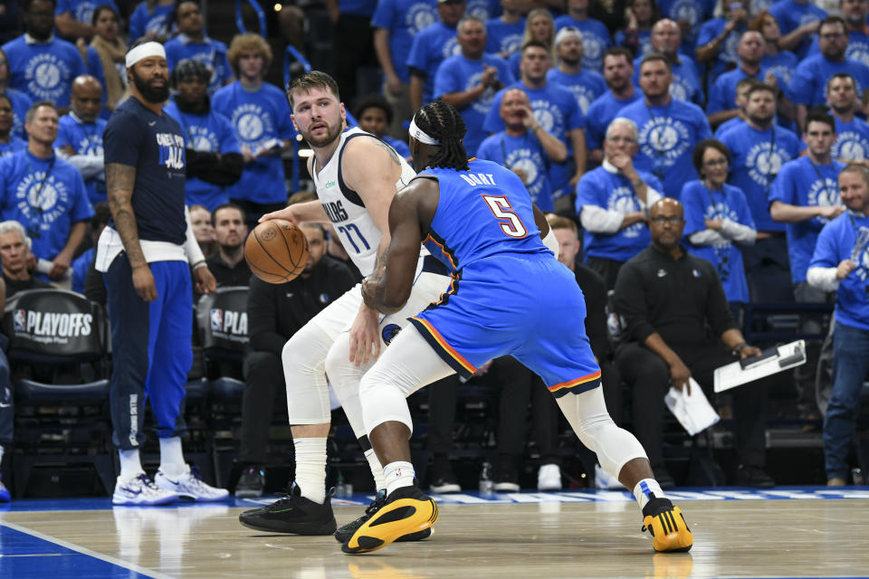 Dallas Mavericks guard Luka Doncic (77) works the floor against Oklahoma City Thunder guard Luguentz Dort (5) during the first half in Game 2 of an NBA basketball second-round playoff series, Thursday, May 9, 2024, in Oklahoma City. (AP Photo/Kyle Phillips)