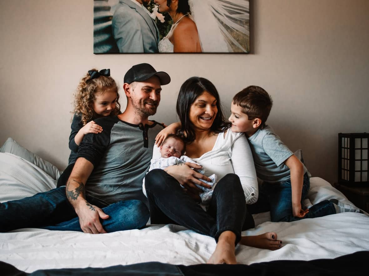 Tara and Mitchell Luce have three children together. They say that after their experience at the hospital before the birth of their latest child Lincoln, they don’t expect to have more. (Amanda Kutsak Photography - image credit)