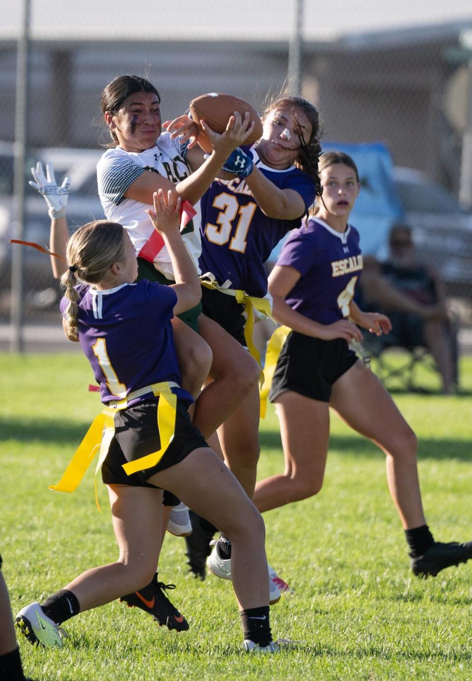 Escalon and Tracy players battle for the ball during the flag football game in Escalon, Calif., Wednesday, Sept. 13, 2023.