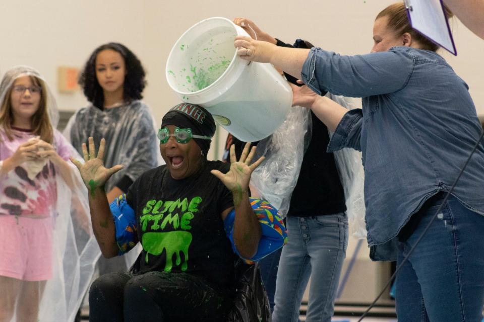 Alliance Intermediate School Assistant Principal Erica Johnson prepares for a dose of slime during the school's Sept. 10, 2023, "Slime Time" event. Students purchased raffle tickets for the chance to pour slime over the school's staff.