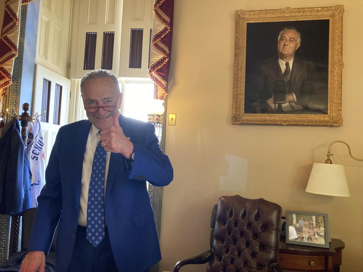 Sen. Chuck Schumer (D-N.Y.) gives a thumbs-up in his office after the Senate approved Democrats' big election-year economic package in Washington, D.C. on Sunday, Aug. 7, 2022. 