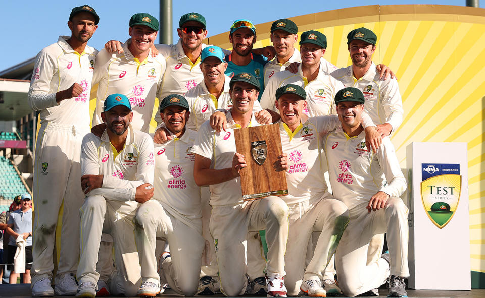 Australia players, pictured here celebrating with the trophy after their 2-0 win over South Africa.