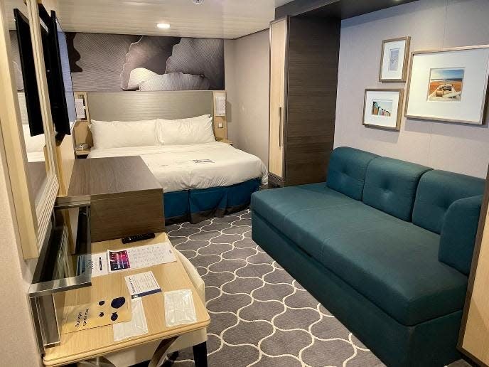 interior of symphony of the seas interior cabin room, view of couch and bed