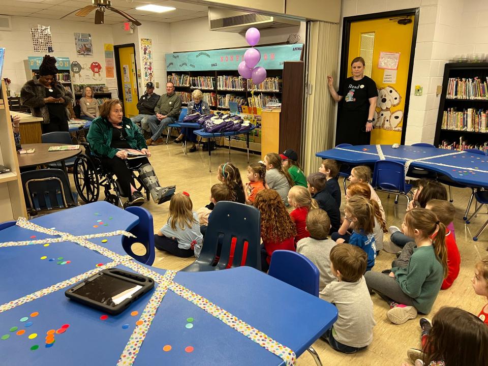 Diane Newell reads a book to A-C Elementary School kindergartners at the dedication of 'Dot's Story Corner' on March 26, 2024. The book space honors Newell's mother, the late Dorothy Newell, a longtime volunteer at the school.