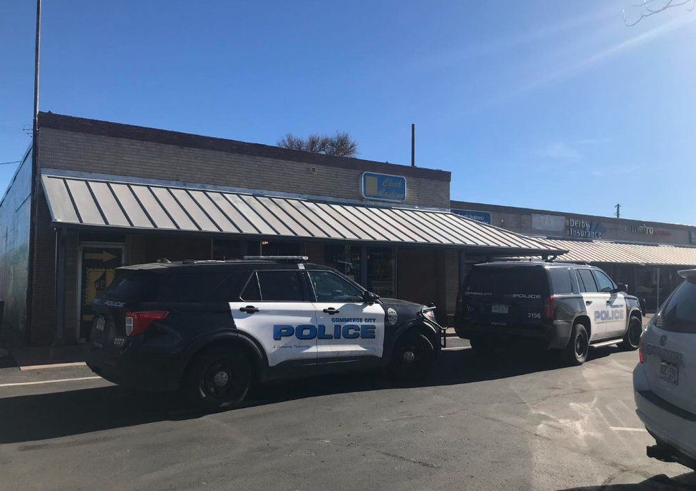 Commerce City police officers parked outside a business where officials say three, armed and masked men robbed a Denver-area check cashing business. In an ironic twist, police said, the suspects' vehicle was stolen during the armed robbery.