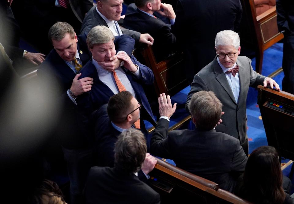 Mike Rogers is restrained as he confronts Matt Gaetz