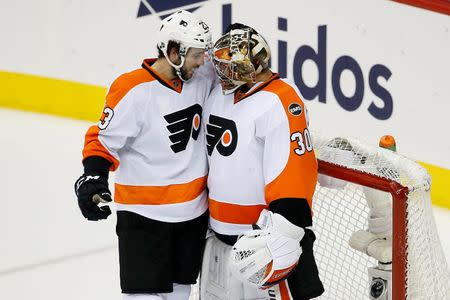 Apr 22, 2016; Washington, DC, USA; Philadelphia Flyers goalie Michal Neuvirth (30) celebrates with Flyers defenseman Brandon Manning (23) after their game against the Washington Capitals in game five of the first round of the 2016 Stanley Cup Playoffs at Verizon Center. Mandatory Credit: Geoff Burke-USA TODAY Sports