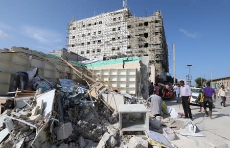 General view shows people at the scene of a suicide car explosion in Mogadishu