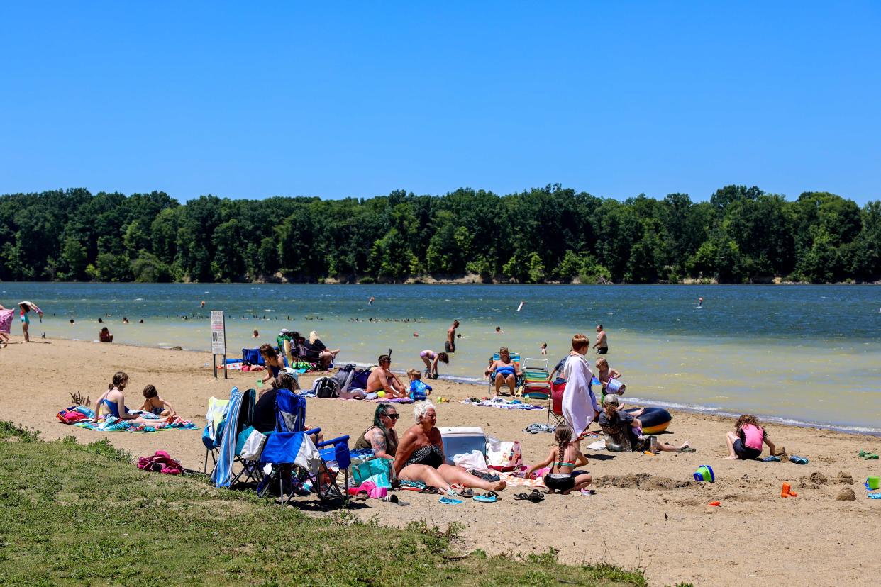 Beachgoers enjoy the sand and water at West Branch State Park, one of at least a few places in Portage County where people can get some relief from the summer heat.