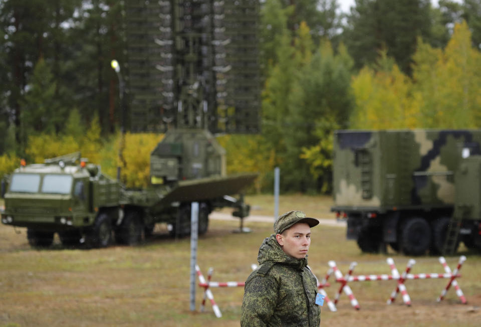 A Russian soldier stands in front of a Nebo-M radar deployed in a forest, during a military exercises on training ground "Telemba", about 80 kilometers (50 miles ) north of the city of Chita during the military exercises Vostok 2018 in Eastern Siberia, Russia, Wednesday, Sept. 12, 2018. Hundreds of thousands Russian troops swept across Siberia on Tuesday in the nation's largest ever war games also joined by China — a powerful show of burgeoning military ties between Moscow and Beijing amid their tensions with the U.S. (AP Photo/Sergei Grits)