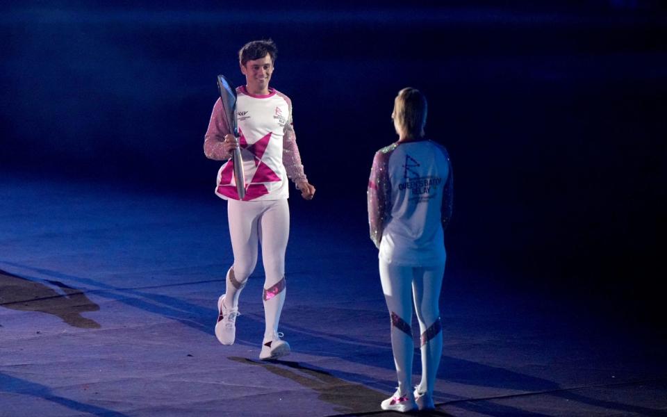 Tom Daley hands the Commonwealth Baton to Alex Danson-Bennett MBE during the opening ceremony - PA