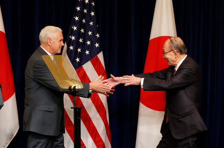 Yuzaburo Mogi (R), honorary chairman of the board of Kikkoman Corp, shakes hands with U.S. Vice President Mike Pence after Pence delivered a speech to U.S. and Japanese business leaders in Tokyo, Japan April 19, 2017. REUTERS/Kim Kyung-Hoon