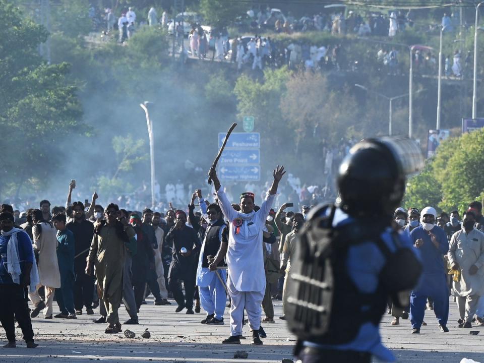 Supporters clash with police outside the building where Khan is being held in custody (AFP/Getty)