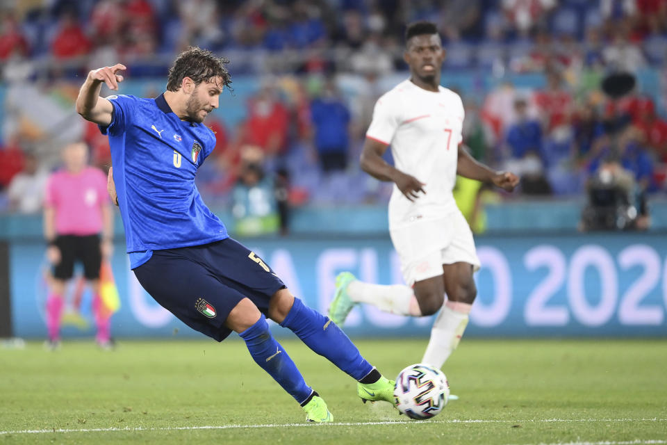 Italy's Manuel Locatelli, left, scores his side's second goal during the Euro 2020 soccer championship group A match between Italy and Switzerland at the Rome Olympic stadium, Wednesday, June 16, 2021. (Alfredo Falcone/LaPresse via AP)