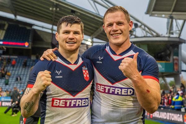 England's John Bateman and Tom Burgess celebrate Saturday's 14-4 win over Tonga in Huddersfield. Picture by Olly Hassell/SWpix.com.