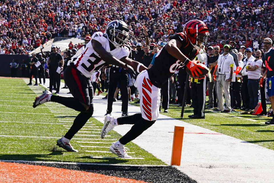 Cincinnati Bengals wide receiver Tyler Boyd (83) reaches for the end zone in front of Atlanta Falcons cornerback Darren Hall (34) in the first half of an NFL football game in Cincinnati, Sunday, Oct. 23, 2022. (AP Photo/Jeff Dean)