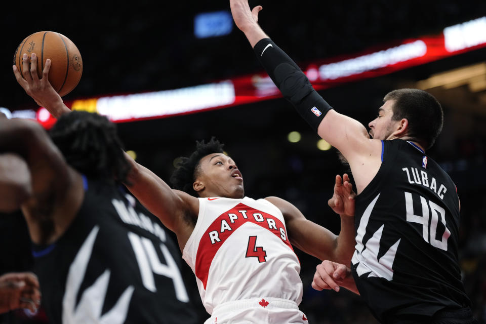 Toronto Raptors forward Scottie Barnes (4) drives against Los Angeles Clippers center Ivica Zubac (40) during the second half of an NBA basketball game Tuesday, Dec. 27, 2022, in Toronto. (Frank Gunn/The Canadian Press via AP)