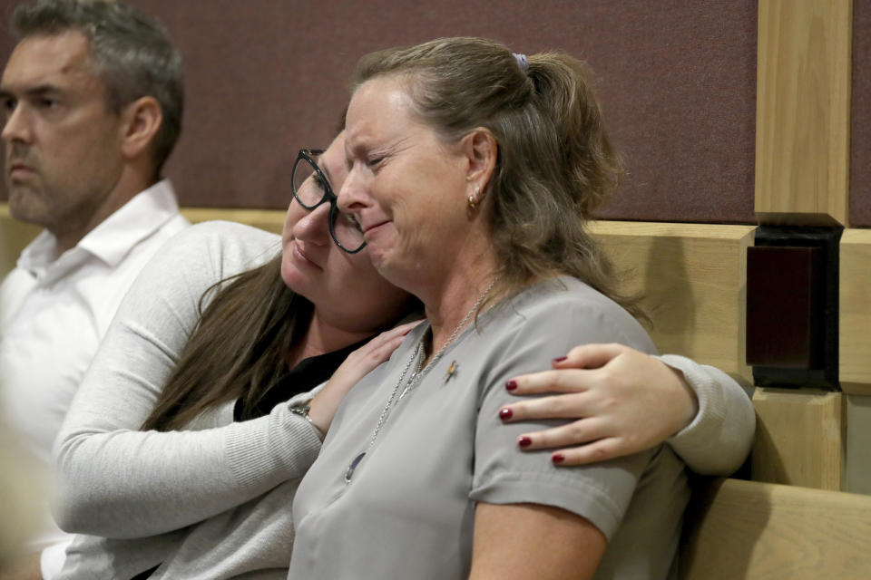 FILE - In this May 1, 2019, file photo, Debbi Hixon, right, the widow of victim Chris Hixon, is consoled in court by family friend Jennifer Valliere during a hearing for Parkland school shooting defendant Nikolas Cruz at the Broward Courthouse in Fort Lauderdale, Fla. It’s been more than 1,000 days since a gunman with an AR-15 rifle burst into a Florida high school, killing 17 people and wounded 17 others. And yet, with Valentine’s Day on Sunday, Feb. 14, 2021, marking the three-year milestone, Cruz’s death penalty is in limbo. (Mike Stocker/South Florida Sun-Sentinel via AP, Pool, File)