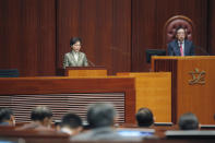 Hong Kong Chief Executive Carrie Lam, left, delivers her policies at chamber of the Legislative Council in Hong Kong, Wednesday, Nov. 25, 2020. Lam said Wednesday that the city's new national security law has been “remarkably effective in restoring stability” after months of political unrest, and that bringing normalcy back to the political system is an urgent priority. (AP Photo/Kin Cheung)