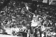 FILE - Atlanta Hawks' Dan Roundfield (32) catches Philadelphia 76ers' Moses Malone (2) on the jaw with an elbow as they battle for a rebound off the 76ers backboard during NBA game, March 27, 1984, in Atlanta. (AP Photo/Joe Holloway)
