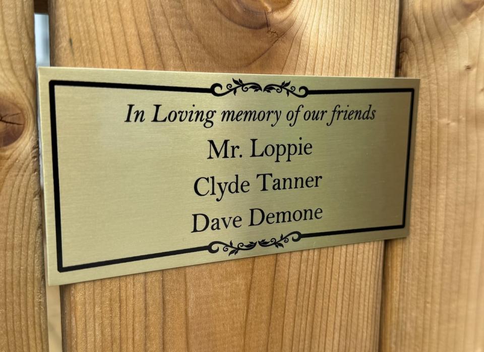 A close up of the plaque made to remember Mr. Loppie, Clyde Tanner and Dave Demone.