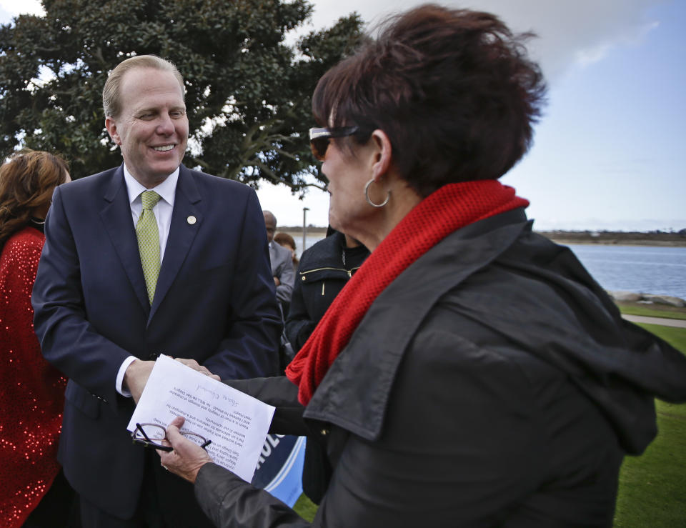 In a Monday, Feb. 3, 2014 photo, San Diego mayoral candidate Kevin Faulconer does a bit of handshaking during a campaign event, in San Diego. Faulconer easily topped a field of 11 candidates in a first round of voting by dominating in wealthier neighborhoods north of the freeway. (AP Photo/Lenny Ignelzi)