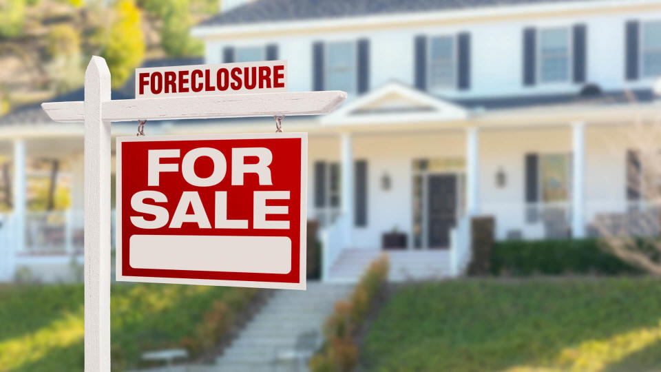 Foreclosure Home For Sale Real Estate Sign in Front of Beautiful Majestic House.