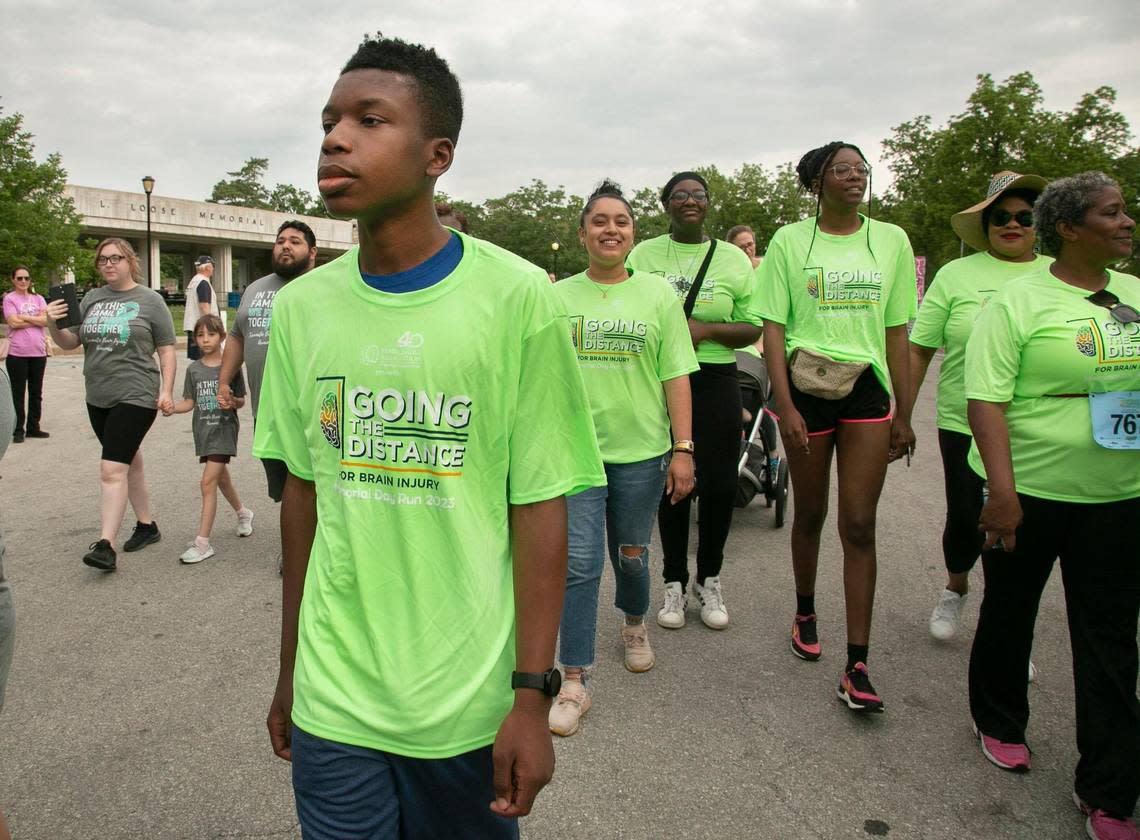 Ralph Yarl, (front) the Staley High School teen shot in the head in April after ringing the wrong doorbell, and family members participated in the 1.5K walk at the Going the Distance for Brain Injury Annual run, Memorial Day, May 29, 2023 at Loose Park.