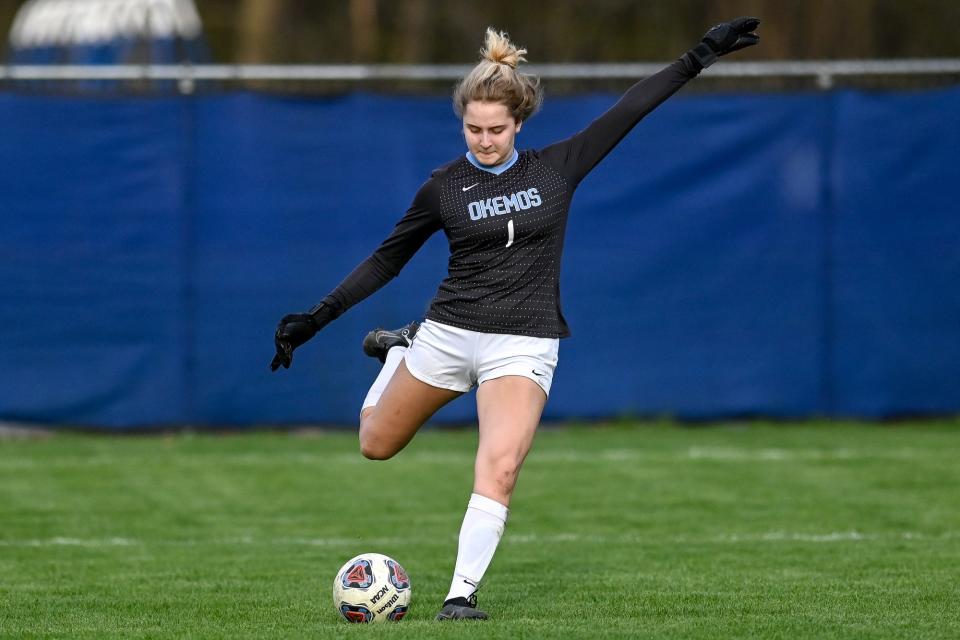 Okemos' goalie Elena Papapolymerou kicks the ball during the first half of the game against DeWitt on Thursday, April 20, 2023, at DeWitt High School.