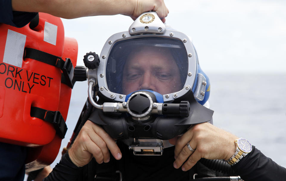 D.J. Roller adjusts his helmet before a dive to the undersea research laboratory Aquarius Reef Base, Friday, July 13, 2012, in the Florida Keys. Also pictured from left to right are Dale Stokes, D.J. Roller, and Mark Patterson. NOAA owns the lab that has rested for decades some 60 feet below the water’s surface on the Conch Reef in the Florida Keys National Marine Sanctuary. But federal budget cuts threaten to close the undersea lab unless it can secure private funding. (AP Photo/Lynne Sladky)