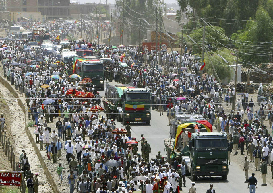 FILE - Thousands of Ethiopians march in Axum, Ethiopia, Monday April 25, 2005, to escort the third and final piece of the ancient Axum obelisk that was returned to Ethiopia from Italy after an almost 70-year dispute over a symbol of African civilization stolen by Italian troops as a war prize. Italy, a long time victim of antiquities theft that has worked for decades to recover its treasures, is coming to terms with the fact that it, too has stolen loot in its museum collections: the relics of a brutal colonial empire that the country hasn't fully reckoned with. (AP Photo/Boris Heger, File)