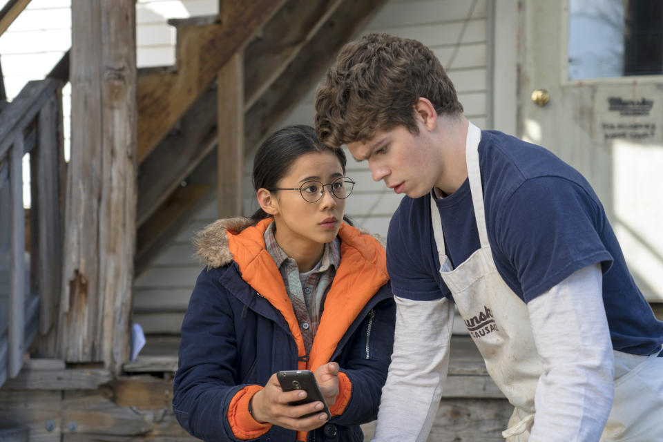 This mage released by Netflix shows Leah Lewis, left, and Daniel Diemer in a scene from "The Half of It," a romance about a high school loner who helps a jock woo the popular girl in school. The film premieres Friday o Netflix. (KC Bailey/Netflix via AP)