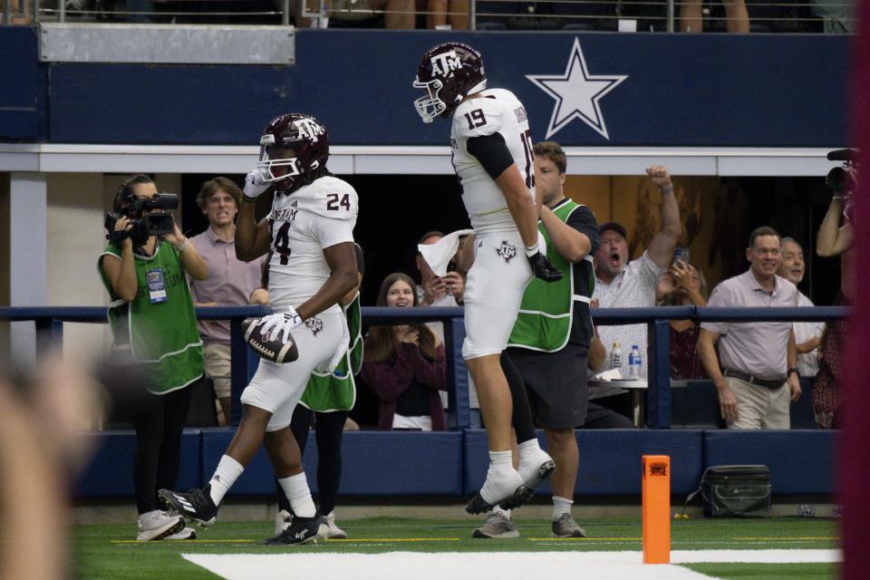 Sep 30, 2023; Arlington, Texas; Texas A&M Aggies running back Earnest Crownover (24) and tight end Jake Johnson (19) celebrate after Crownover scores a touchdown against the Arkansas Razorbacks during the first half at AT&T Stadium. Jerome Miron-USA TODAY Sports