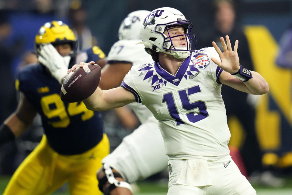 TCU quarterback Max Duggan (15) throws against Michigan during the first half of the Fiesta Bowl NCAA college football semifinal playoff game, Saturday, Dec. 31, 2022, in Glendale, Ariz. (AP Photo/Ross D. Franklin)