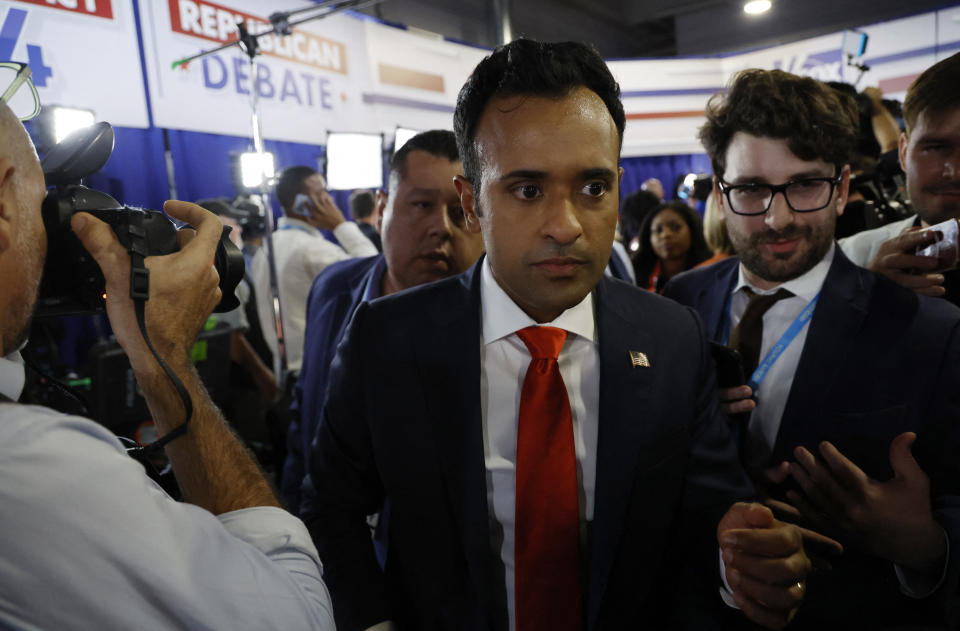 Vivek Ramaswamy makes his way through a crowd of reporters after the first Republican primary debate in Milwaukee.