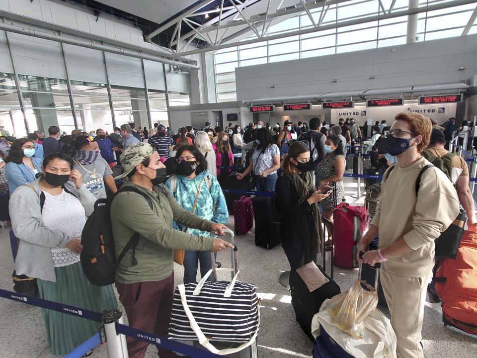 Airline passengers wait to check-in at George Bush Intercontinental Airport Sunday, May 16, 2021, in Houston. Airline travel is increasing as more Americans are getting the COVID-19 vaccination. (AP Photo/David J. Phillip)